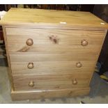 A modern rectangular pine chest of three long drawers, 77cm wide, 77cm high and a pine cheval