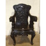 A carved stained wood hall chair in the Chinese taste, carved with dragons.