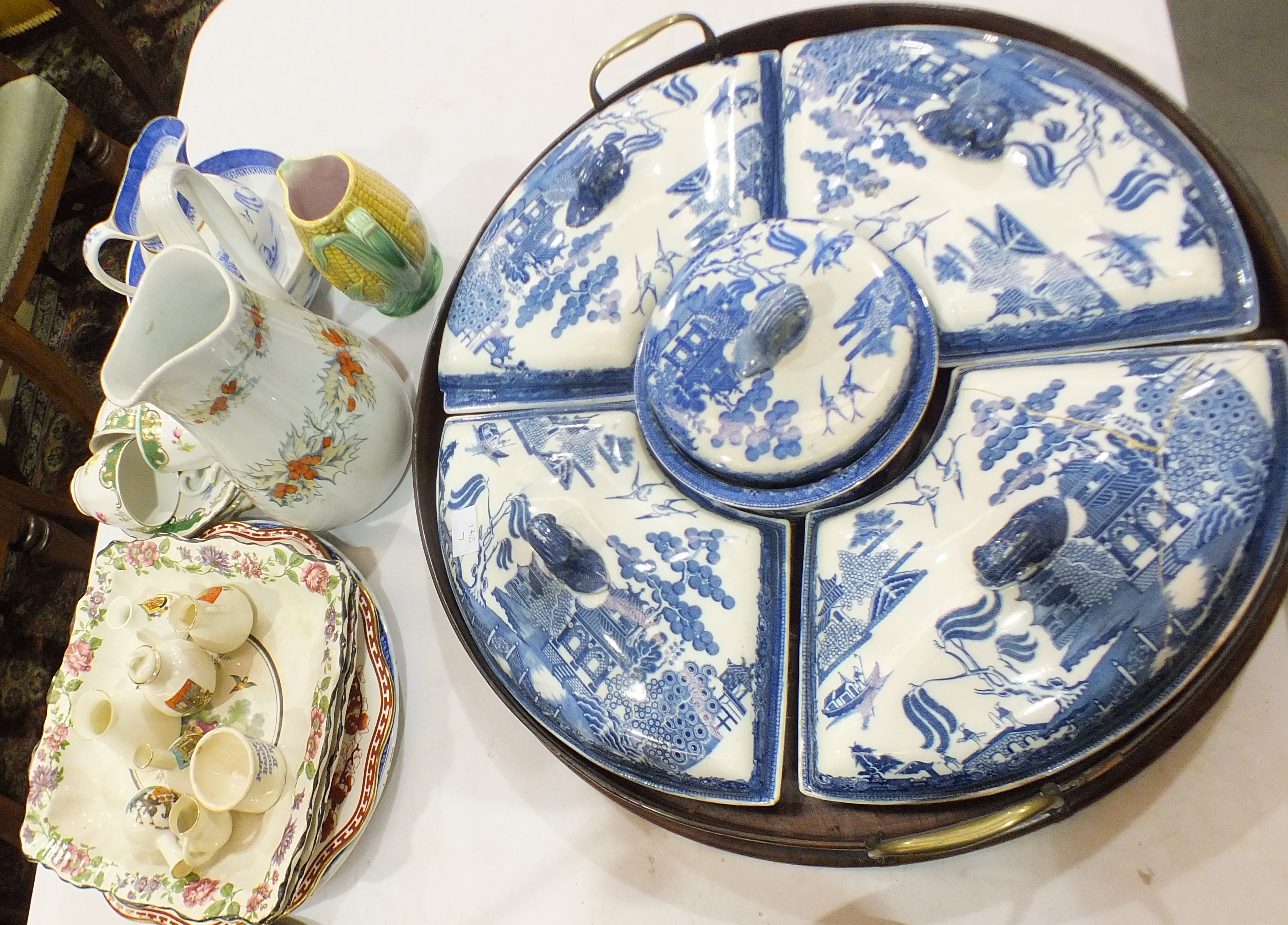 A 19th century blue and white willow pattern supper set, comprising four crescent shaped dishes