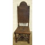 A reproduction 17th century continental walnut high back chair with studded and tooled leather