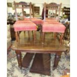 An oak extending dining table, 122cm wide, 130cm long, including two leaves, and four Edwardian