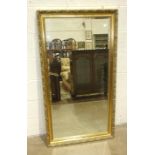 A modern gilt framed rectangular bevelled edge wall mirror, 73.5 x 135cm.