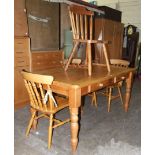 A modern pine kitchen table with two drawers, on turned legs, a pine occasional table in the form of