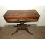 A George IV mahogany fold-over card table on turned and carved column and four hipped sabre legs,