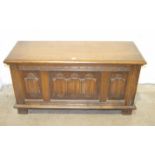A mid-20th century oak blanket chest with linen-fold decorated front panel, 95cm wide, 47cm high,