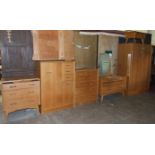 A suite of oak finish G-Plan bedroom furniture, including: wardrobe, tallboy, chest of five drawers,