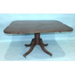 An early-19th century mahogany tilt-top dining table, on turned column and quadruped supports, 140 x