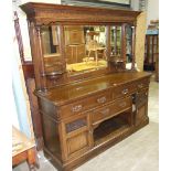 A large late 19th/early20th century mirror-backed sideboard, the mirrored back with dentil cornice