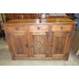 An oak dresser base in the Arts and Crafts taste, having an arrangement of three drawers and three