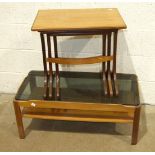 A G Plan nest of three teak tables, 56cm wide, and a Myer smoked glass top two-tier coffee table, 86