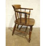 An early 20th century elm seated "smokers" chair.
