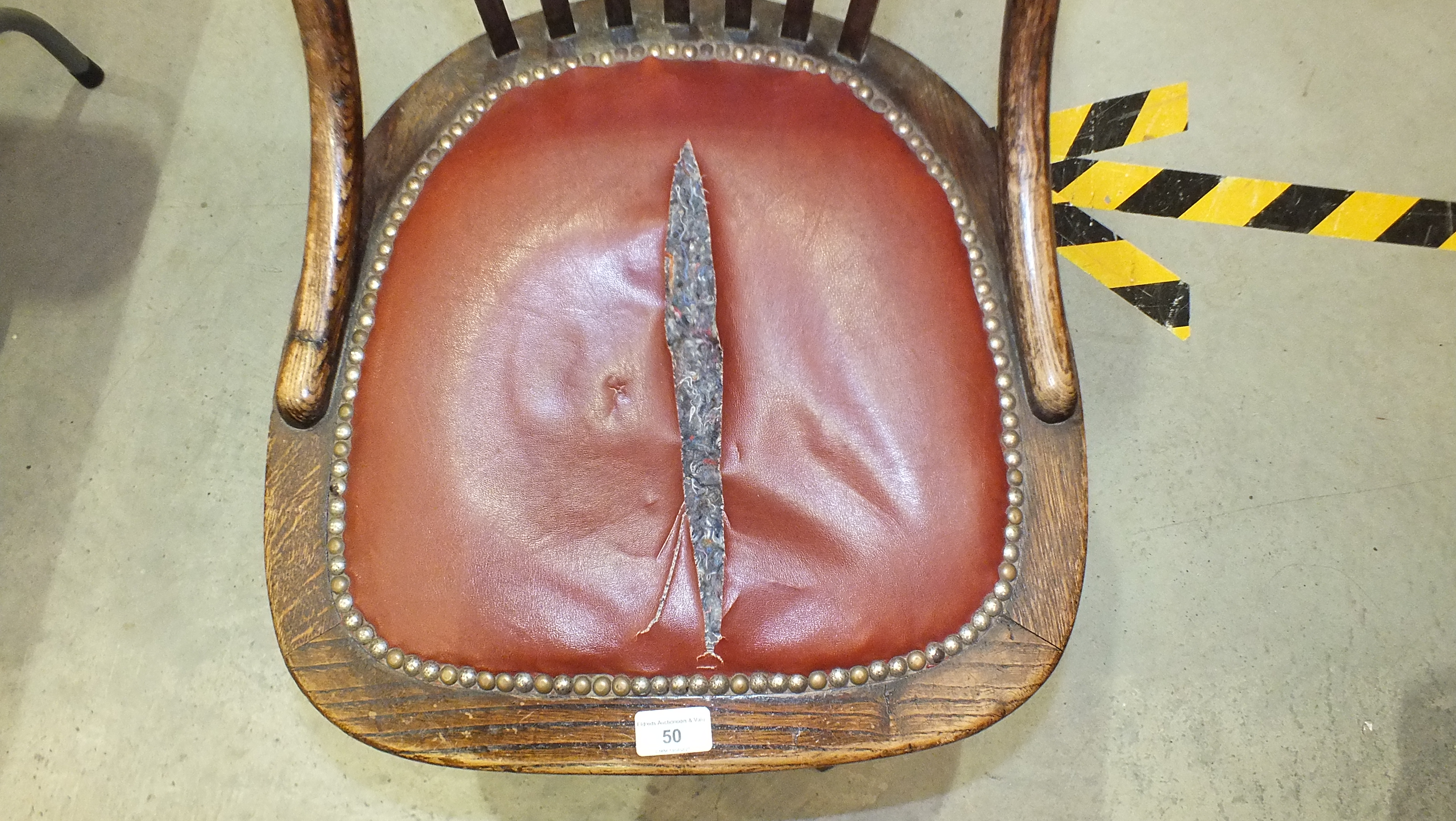 A 1920's oak revolving office chair on quadruped base, (seat torn). - Image 3 of 3