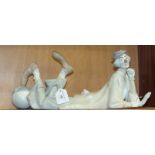 A Lladro figure 'Clown', lying on his front with head resting on one arm and a ball under one of his
