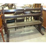 A 20th century stained wood station bench, with moveable back rest to allow seating on either