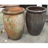 Two glazed pottery planters of slightly baluster ribbed form, 62cm high.