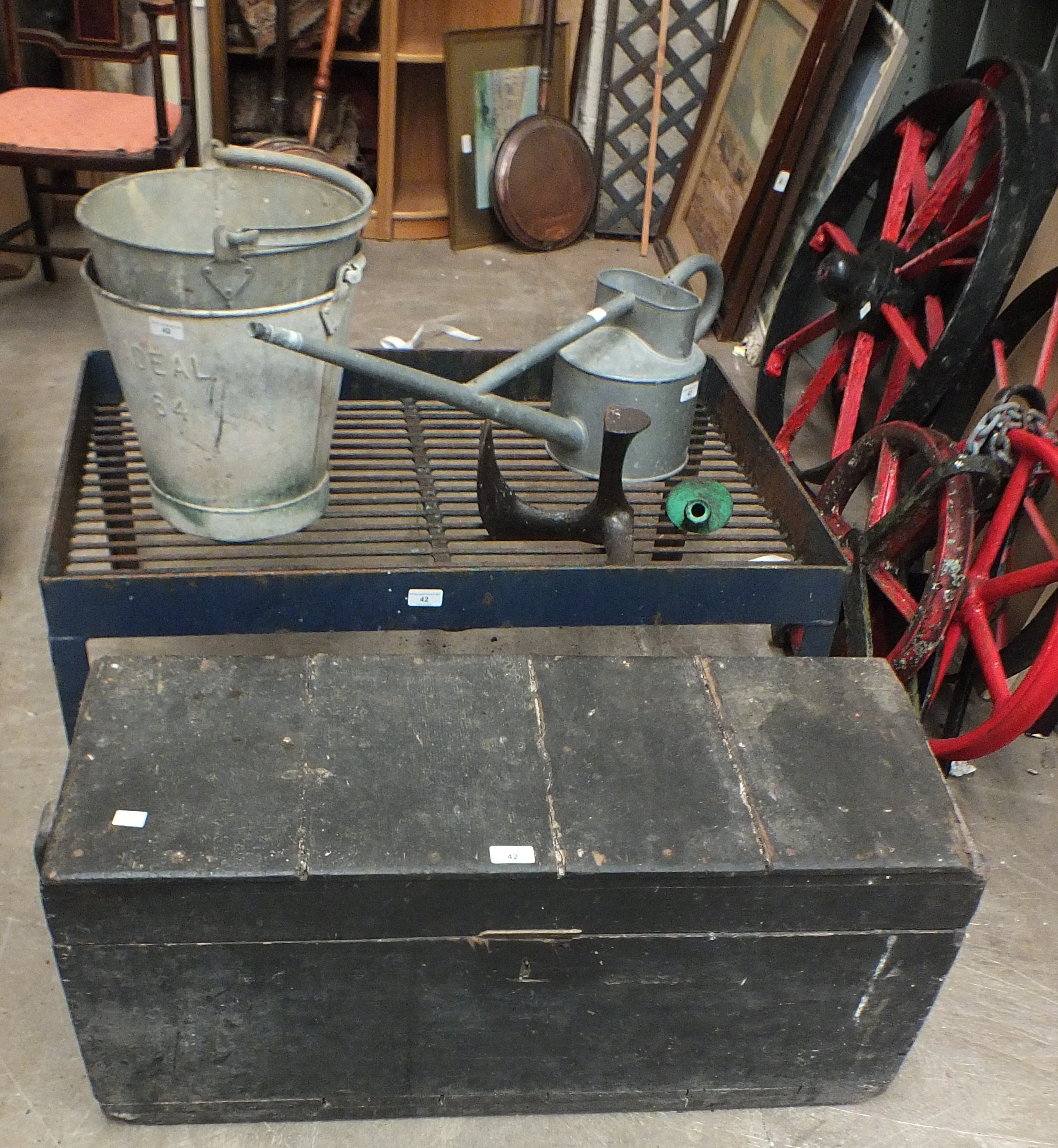 An iron milk churn stand, 25 x 94cm, a galvanised watering can, two buckets and other items.