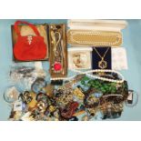 A quantity of costume jewellery, including hat pins and a vintage evening bag.
