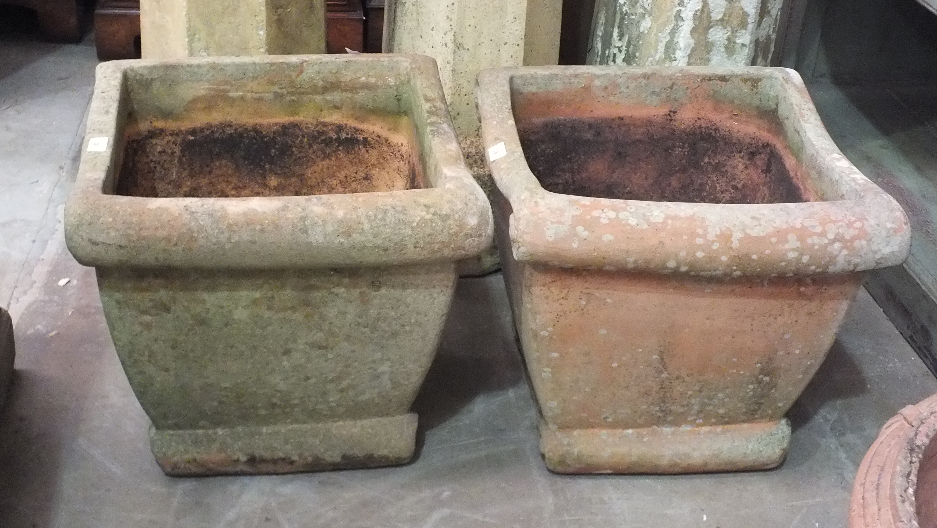 A pair of terracotta-coloured pottery square-form planters, 44cm high, 47cm square, (2).