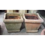 A pair of terracotta-coloured pottery square-form planters, 44cm high, 47cm square, (2).