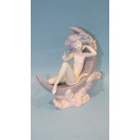 A Lladro figure 'Moon Glow', depicting a naked nymph on a crescent moon, 17.5cm high.