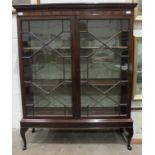A mahogany bookcase with dentil cornice above two astragal-glazed doors, on later stand, 110cm wide,