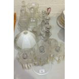 A collection of glassware, including decanters, candle holders, bowls, etc.