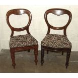 Eleven similar Victorian mahogany balloon-back dining chairs, all with drop-in seats and turned