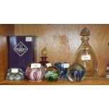 A Langham glass paperweight, three other glass paperweights, a Murano glass scent bottle and stopper