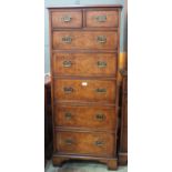 A similar tall chest of two short and five graduated long drawers, 130cm high, 60cm wide.