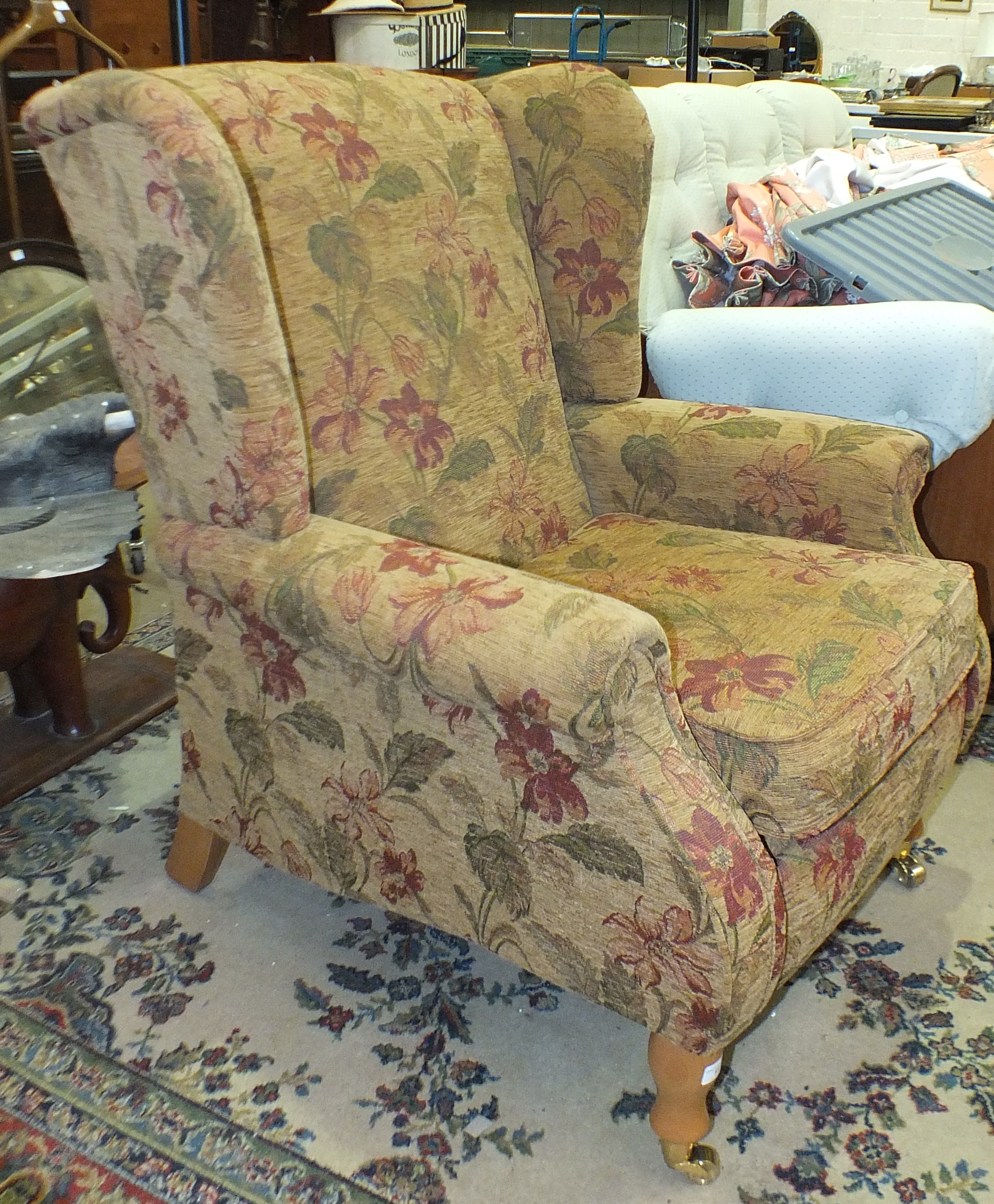 A modern upholstered Parker-Knoll wing armchair, on feet with castors. - Image 2 of 2