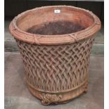 A modern terracotta planter decorated with lattice work, on foliate feet, 52cm high, 54cm diameter.