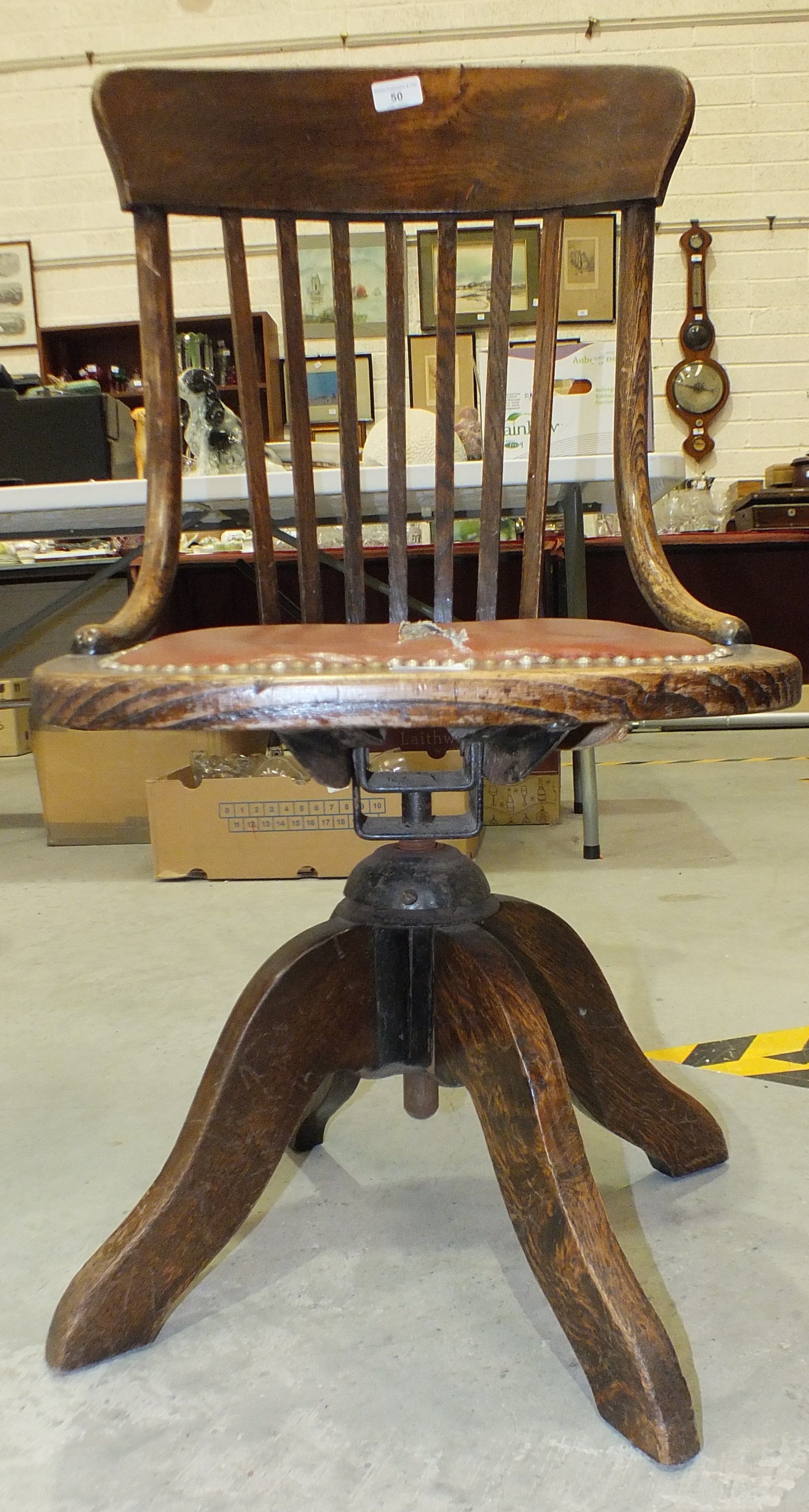 A 1920's oak revolving office chair on quadruped base, (seat torn). - Image 2 of 3