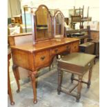 A walnut dressing table fitted with three drawers, 123cm wide, 76cm high, a triptych mirror and an