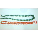 A string of graduated malachite beads, 54cm long and a string of coral twigs and beads, (2).