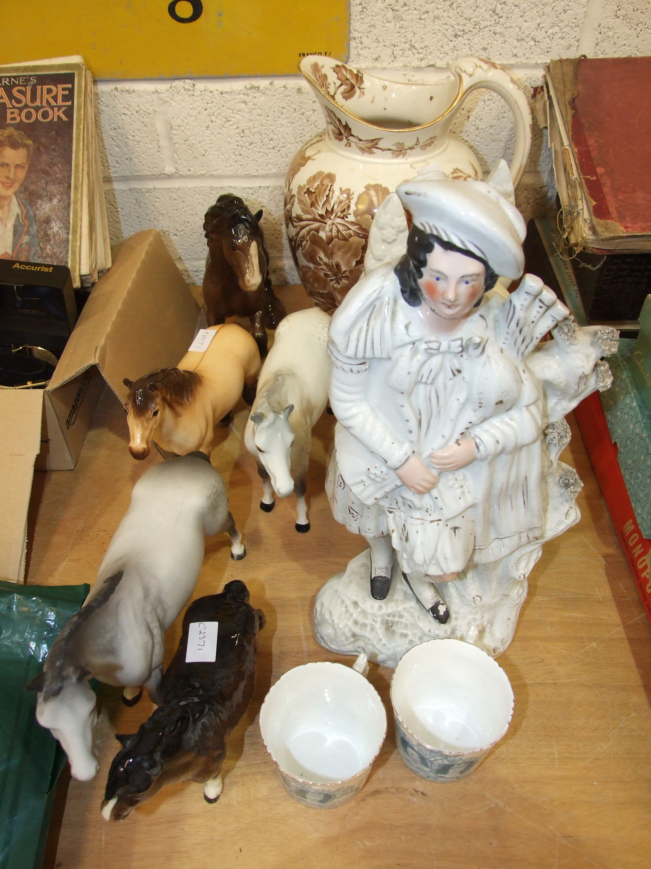 A Beswick Palomino horse, other Beswick models, a Staffordshire flat-back figure of a highlander and