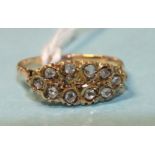 An unmarked gold ring set ten rose-cut diamonds, (tested as 18ct gold, approximately), size P, 2.9g.