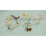 A collection of eleven small Swarovski glass figures: chimpanzee carrying a bunch of bananas,