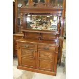 An Edwardian walnut sideboard, the mirrored back above two drawers and two cupboard doors, 120cm