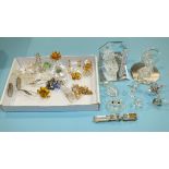 A collection of seven small Swarovski glass and gilt figures: a locomotive, cradle, grand piano,