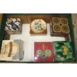 A set of twelve 19th century polychrome-decorated ceramic tiles, 13cm square, possibly for a