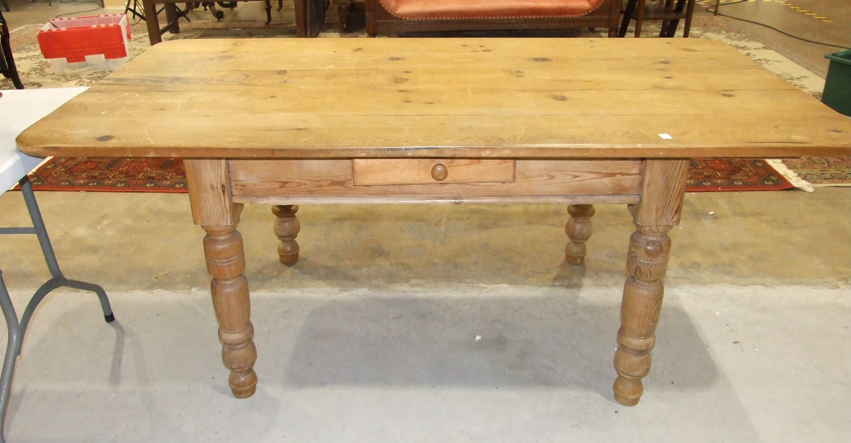 A pine kitchen table fitted with a single drawer, on turned legs, 180 x 94cm.