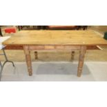 A pine kitchen table fitted with a single drawer, on turned legs, 180 x 94cm.