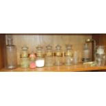A collection of six named apothecary glass jars, with painted gilt and black labels and others, some