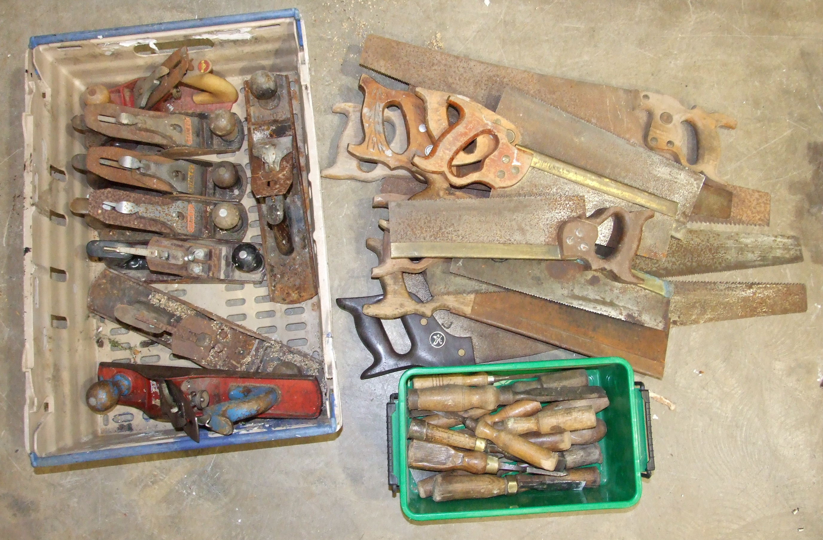 A collection of Stanley and other metal planes, vintage chisels and hand saws.