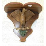 A Continental carved wood clock bracket supported by a carved wood winged bird, (later painted), a