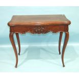 A 19th century mahogany fold-over card table, the serpentine top with carved frieze and carved