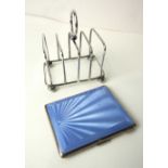 A pale blue enamelled silver cigarette case, Birmingham 1947 and an Edwardian five-bar toast rack,