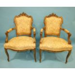 A pair of Louis XV-style gilt-painted carved wood armchairs, on cabriole front legs with upholstered