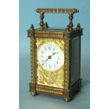 A late-19th/early-20th century brass carriage timepiece with ornate gorge case, the face with cut