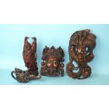 A carved wood Chinese wall hanging in the form of a dragon, 26cm high, another in the form of a mask